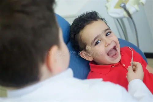 Pediatric dentist examining a young child's teeth at Anandbagh dental clinic, Hyderabad — Dr. Sri Sushma Dental Clinic